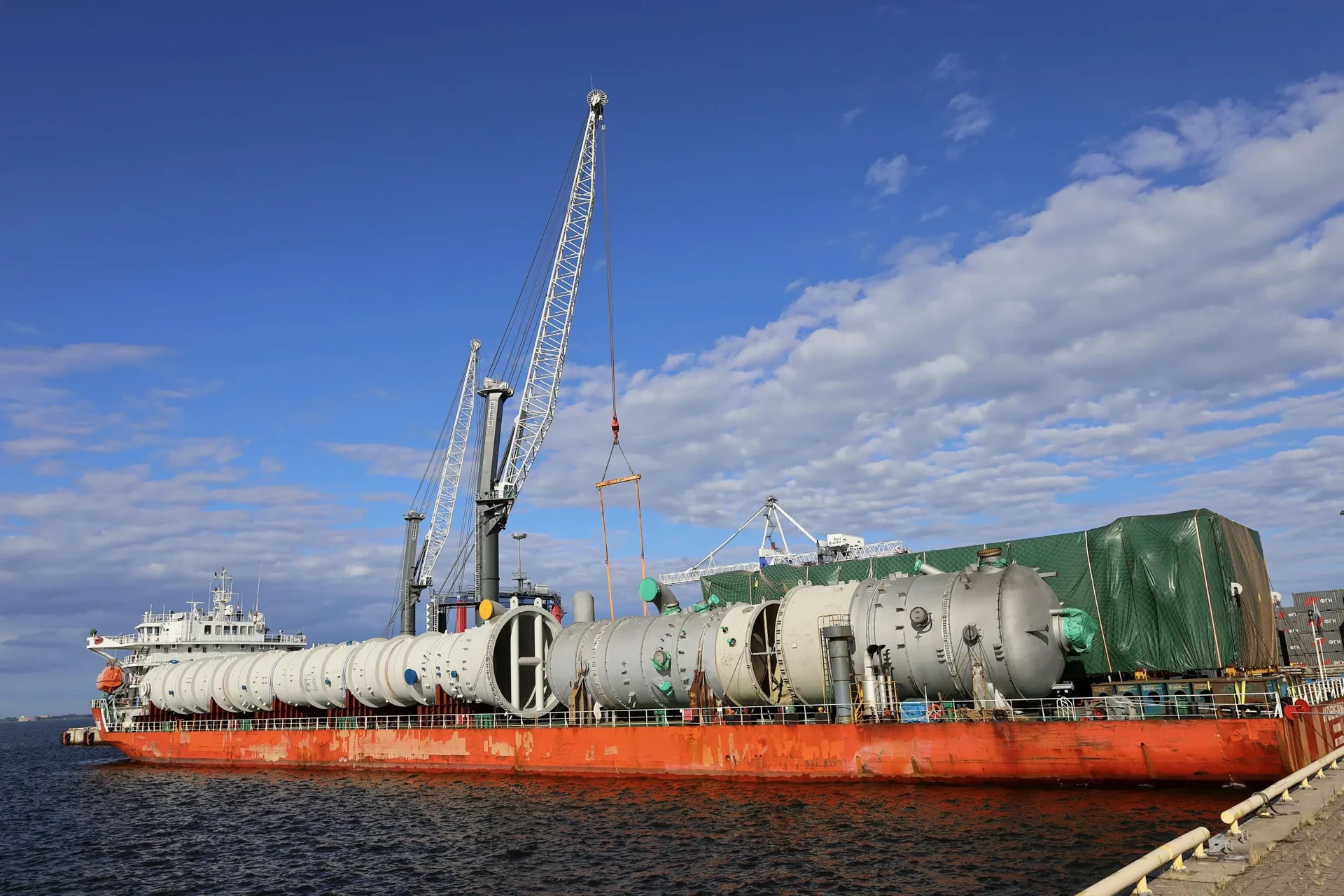 Vessel carrying out-of-gauge industrial equipment alongside Bronka Port